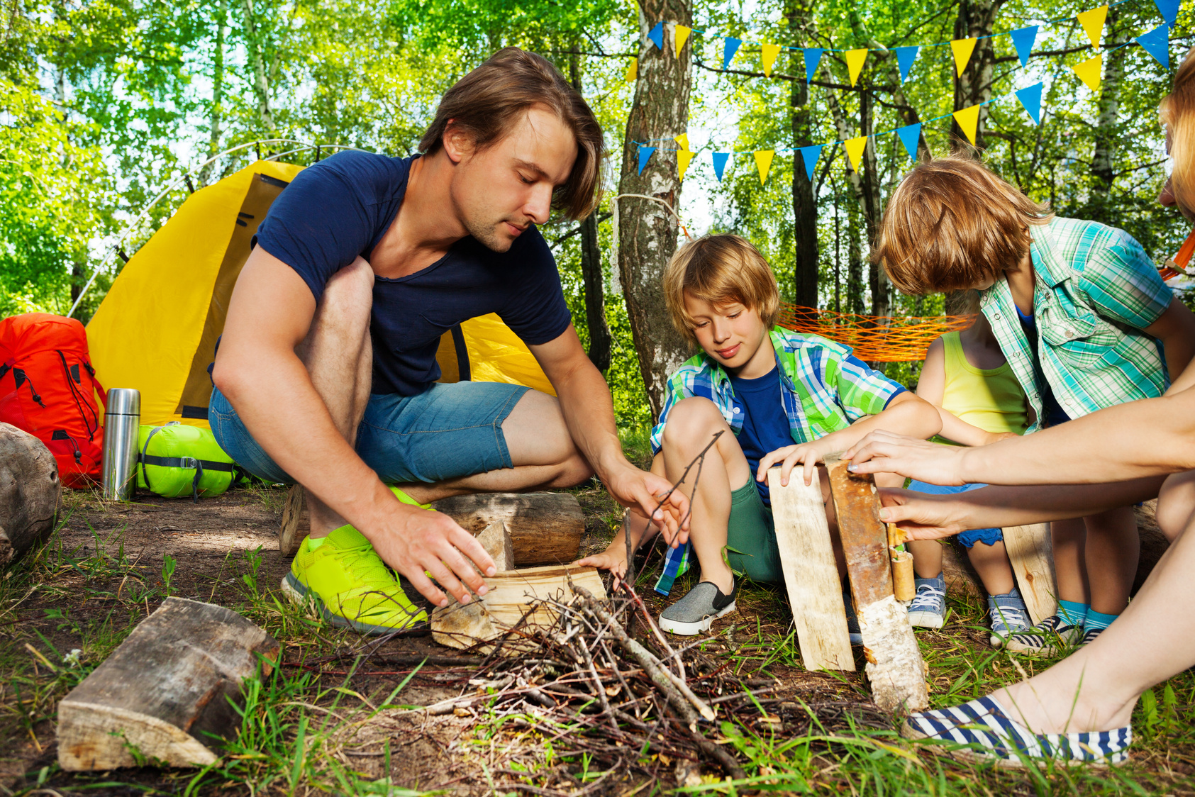 Father Teaching Kids to Make a Camp Fire