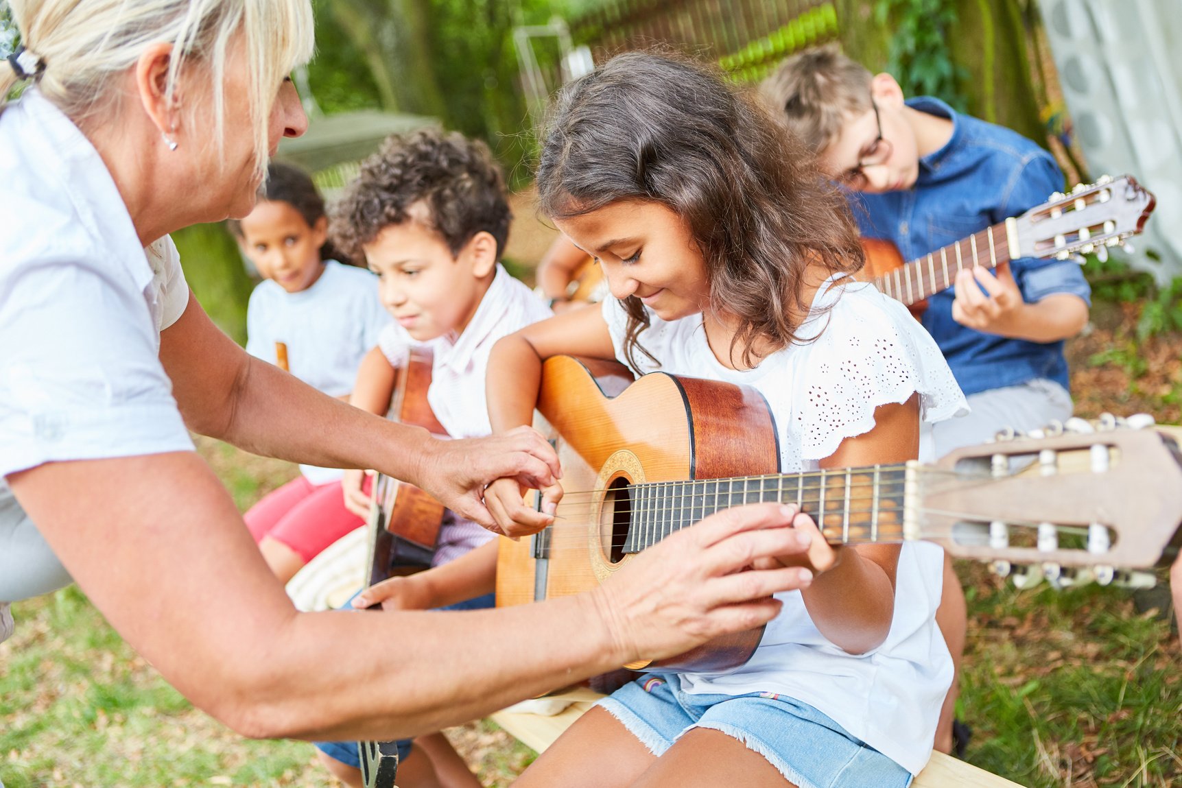 Group of Kids Learns to Play Guitar in Summer Camp